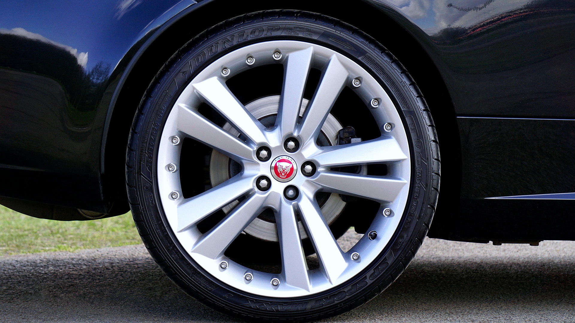 Silver alloy wheel on a dark car, photographed in the UK