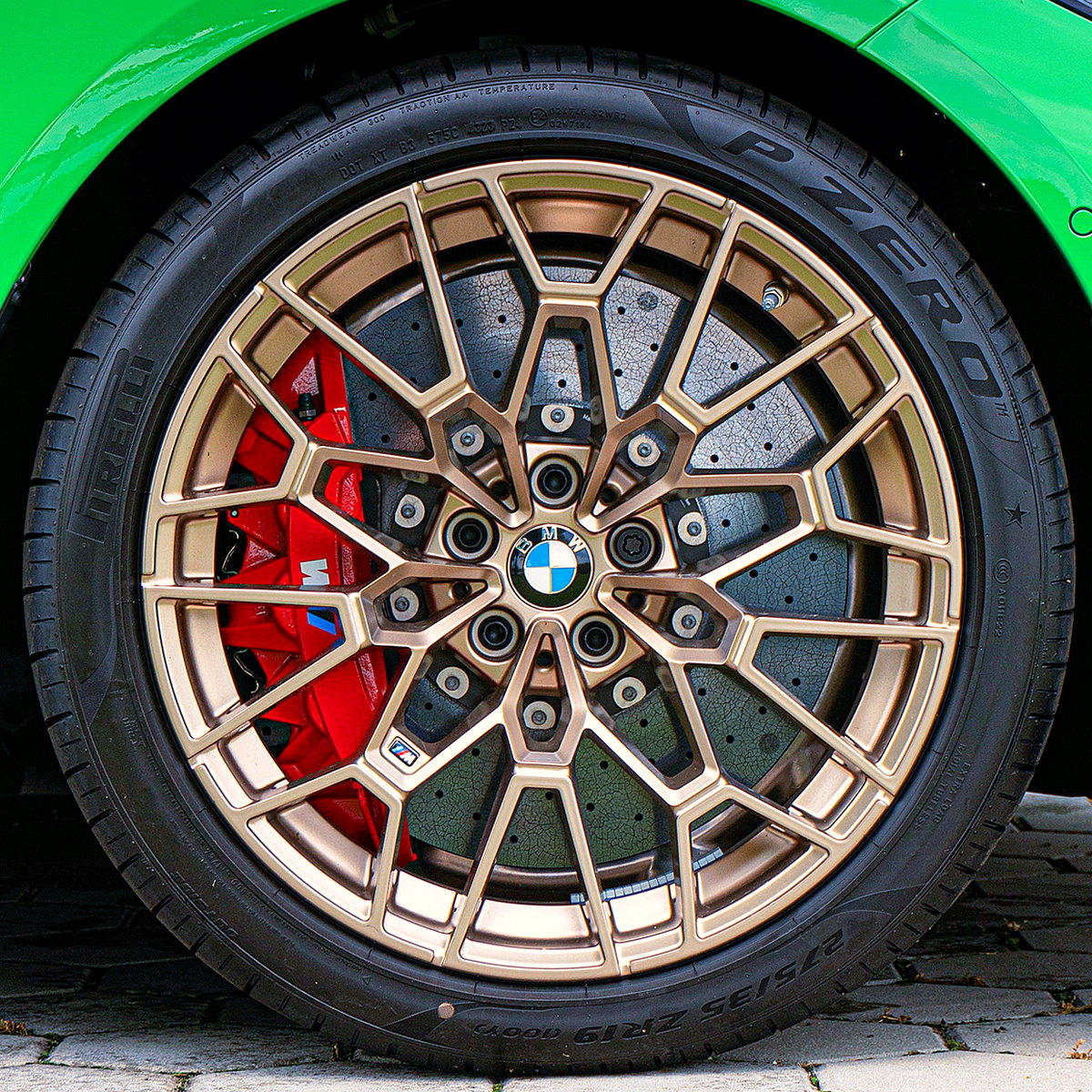 Bronze finished multi-spoke alloy on a green car